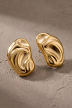Close-up of the sculpted folds of the gold molten bean studs